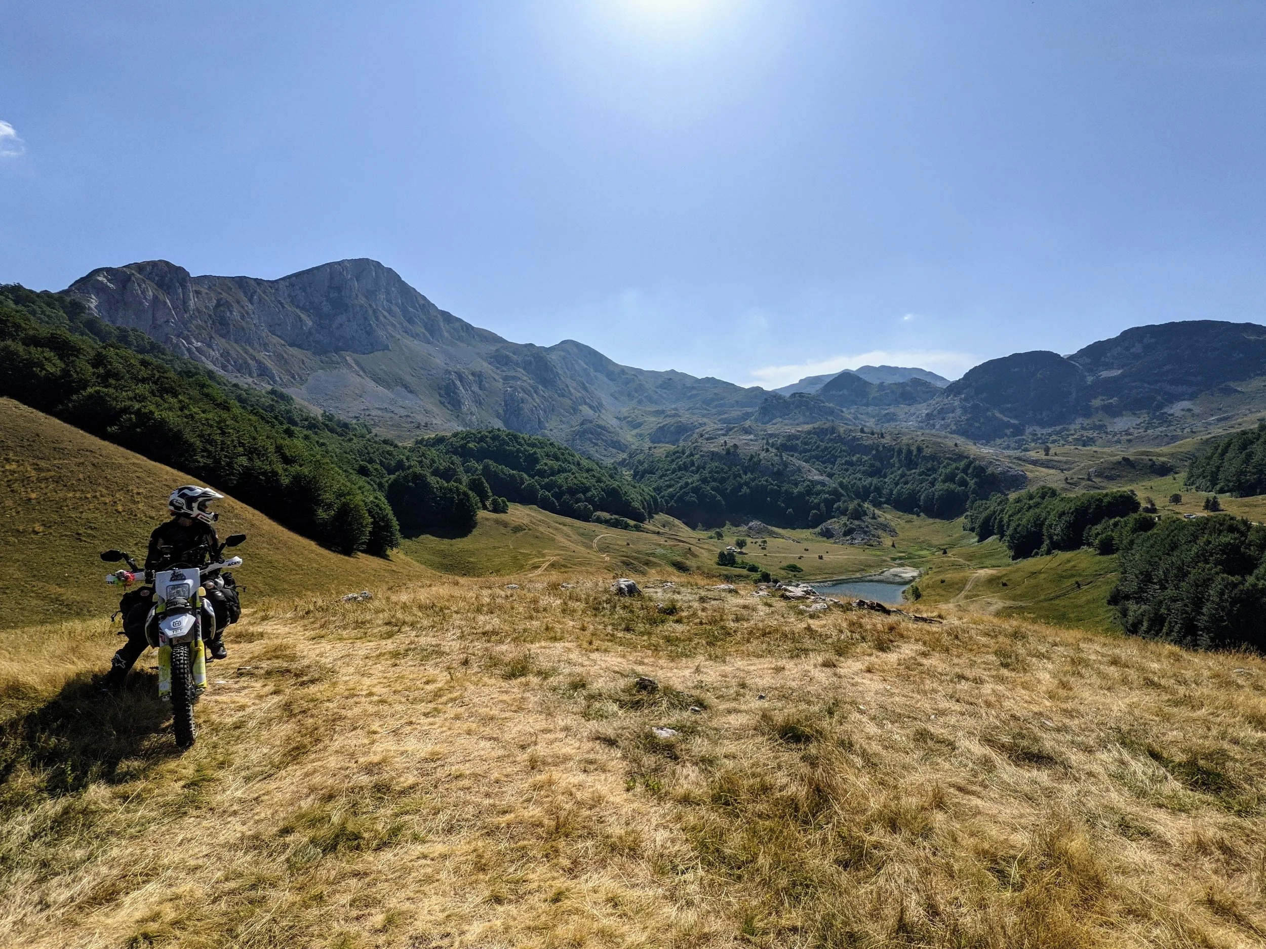 Motocyklistka na TET nad jeziorem w górach Bośni